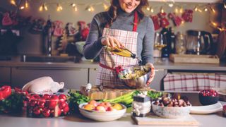 A woman preparing Christmas dinner in the kitchen