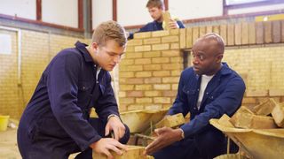 A bricklaying teacher teaching a new student