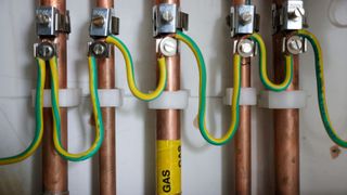 Copper pipework with a yellow and green earth wire