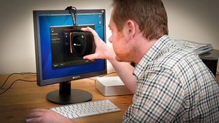 Man sat at desk using one of the best monitor calibrators