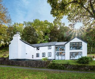 White stone cottage in Welsh valley with modern extension