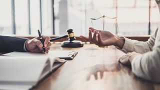 Two people having a legal discussion in an office