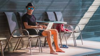 Man working on a laptop outdoors