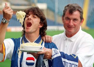 Benito Carbone, alongside manager David Pleat, eats spaghetti after signing for Sheffield Wednesday in October 1996