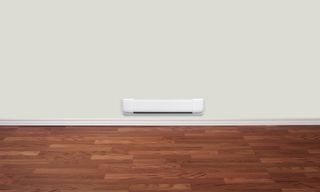 A baseboard heater shown in a room with a wooden floor