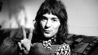 Keyboard player Ian McLagan doing a peace sign in the late 1960s