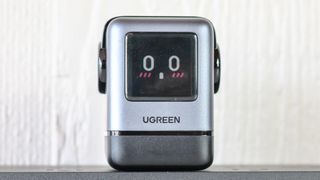 The Ugreen Uno Charger 100W plugged into a power strip on a table