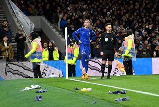 Cole Palmer of Chelsea looks on, as objects are thrown towards him from the stands during the Premier League match between Tottenham Hotspur FC and Chelsea FC at Tottenham Hotspur Stadium on December 08, 2024 in London, England