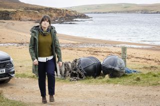 Tosh walking along a beach in Shetland season 9 episode 3 