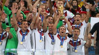 Germany captain Philipp Lahm holds the trophy and celebrate with his teammates during the trophy presentation after the 2014 FIFA World Cup Brazil final between Germany and Argentina at the Maracana in Rio de Janeiro, Brazil on 11 July, 2010.