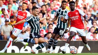 Bukayo Saka of Arsenal is challenged by Diogo Dalot of Manchester United during the Premier League match between Arsenal FC and Manchester United at Emirates Stadium on September 03, 2023 in London, England.