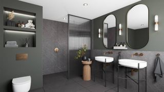 bathroom with dark green painted walls, grey marble effect panelling, walk in shower area and two white sinks on black stands with mirrors above