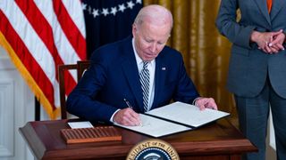 US President Joe Biden signs an executive order with US Vice President Kamala Harris during an event in the East Room of the White House in Washington, DC, US, on Monday, Oct. 30, 2023. Biden is directing the US government to take a sweeping approach to artificial intelligence regulation, his most significant action yet to rein in an emerging technology that has sparked both concern and acclaim. Photographer: Al Drago/Bloomberg via Getty Images