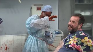 Adam Sandler smiles as he bleeds all over Chris Rock during an SNL sketch.