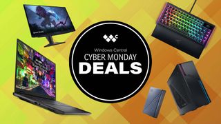 An Alienware monitor, Alienware laptops, Razer keyboard, ASUS Gaming Desktop, and Western Digital HDD next to a sign that says &quot;Cyber Monday Deals.&quot;