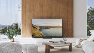 Panasonic Z95B in a modern living room environment with a coastal scene on screen