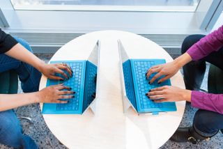 Two laptops placed opposite to each other