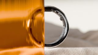 The Circular Ring 2, up close, with half of the device slightly obstructed by orange glass in the foreground