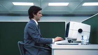 Adam Scott as Mark Scout in Severance, at his desk