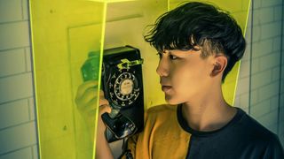 Boy holding payphone receiver