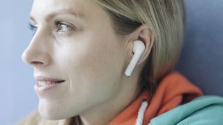 Woman listening to wireless earbuds