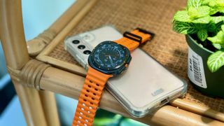 The Samsung Galaxy Watch Ultra sitting atop the Samsung Galaxy S22 Plus.