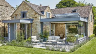 Two glass box extensions added onto a traditional stone cottage