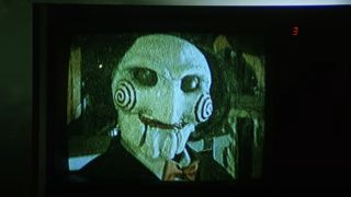 Billy the Puppet is looking terrifying as he broadcasts on a TV in 2004&#039;s Saw.