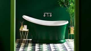 green-painted roll top bath in a bathroom with green walls