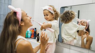 A toddler brushing their teeth with an one of the best electric toothbrushes for kids