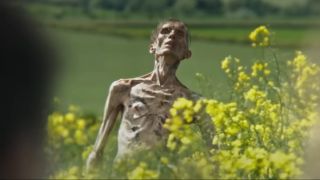 A Cillian Murphy looking Infected rises from a field in 28 Years Later.