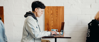 Person using laptop in cafe