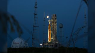 Full moon shines on Artemis I Space Launch System (SLS) and Orion spacecraft