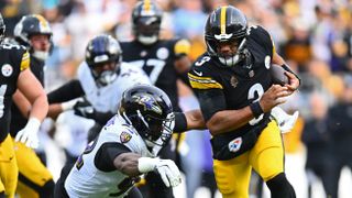 Baltimore Ravens&#039; Nnamdi Madubuike attempts to tackle Pittsburgh Steelers&#039; Russell Wilson