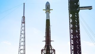 A SpaceX Falcon 9 rocket on the launch pad carrying four Astranis satellites