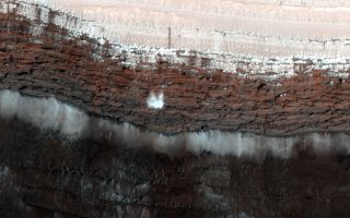 Chunks of frost composed of carbon dioxide begin to break apart and crash to the Martian surface.