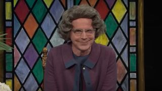 Dana Carvey smiles at the camera while playing The Church Lady on SNL.