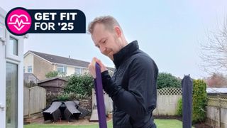 Fitness editor Matt Evans doing a bicep burl with resistance band outdoors