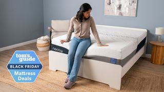 A tom&#039;s guide tester sitting on the Nectar Luxe mattress