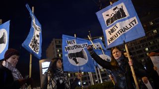 A small group of protestors supporting net neutrality protest against a plan by Federal Communications Commission (FCC) head Ajit Pai, during a protest on December 7, 2017 in Washington. Demonstrations in support of net neutrality are planned nation-wide at hundreds of Verizon stores and other venues. / AFP PHOTO / Andrew CABALLERO-REYNOLDS (Photo credit should read ANDREW CABALLERO-REYNOLDS/AFP via Getty Images)