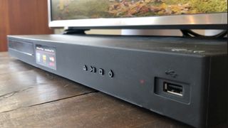 LG Blu-ray player on stand in living room