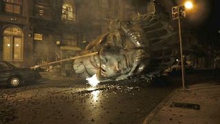 An image of the head of the Statue of Liberty in the streets of NYC.