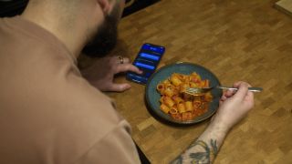 Author eating pasta while using Lara AI to translate from Italian to English