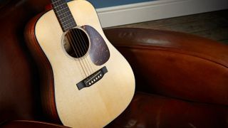 A Martin DJR-10E acoustic guitar on a chair 