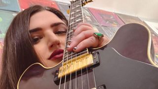 Ella Feingold holding her guitar