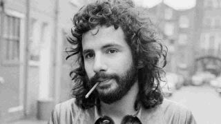 Cat Stevens smoking a cigarette and wearing a leather jacket in the early 70s