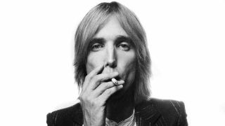 Tom Petty posing for a photograph smoking a cigarette