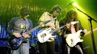 From left, Joe Satriani, Steve Vai, and Yngvie Malmsteen perform, Chicago, Illinois, October 24, 2003