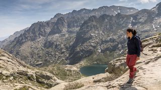 Female hiker descending to Lake de Melo