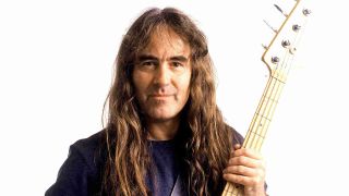 Iron Maiden’s Steve Harris holding a bass guitar